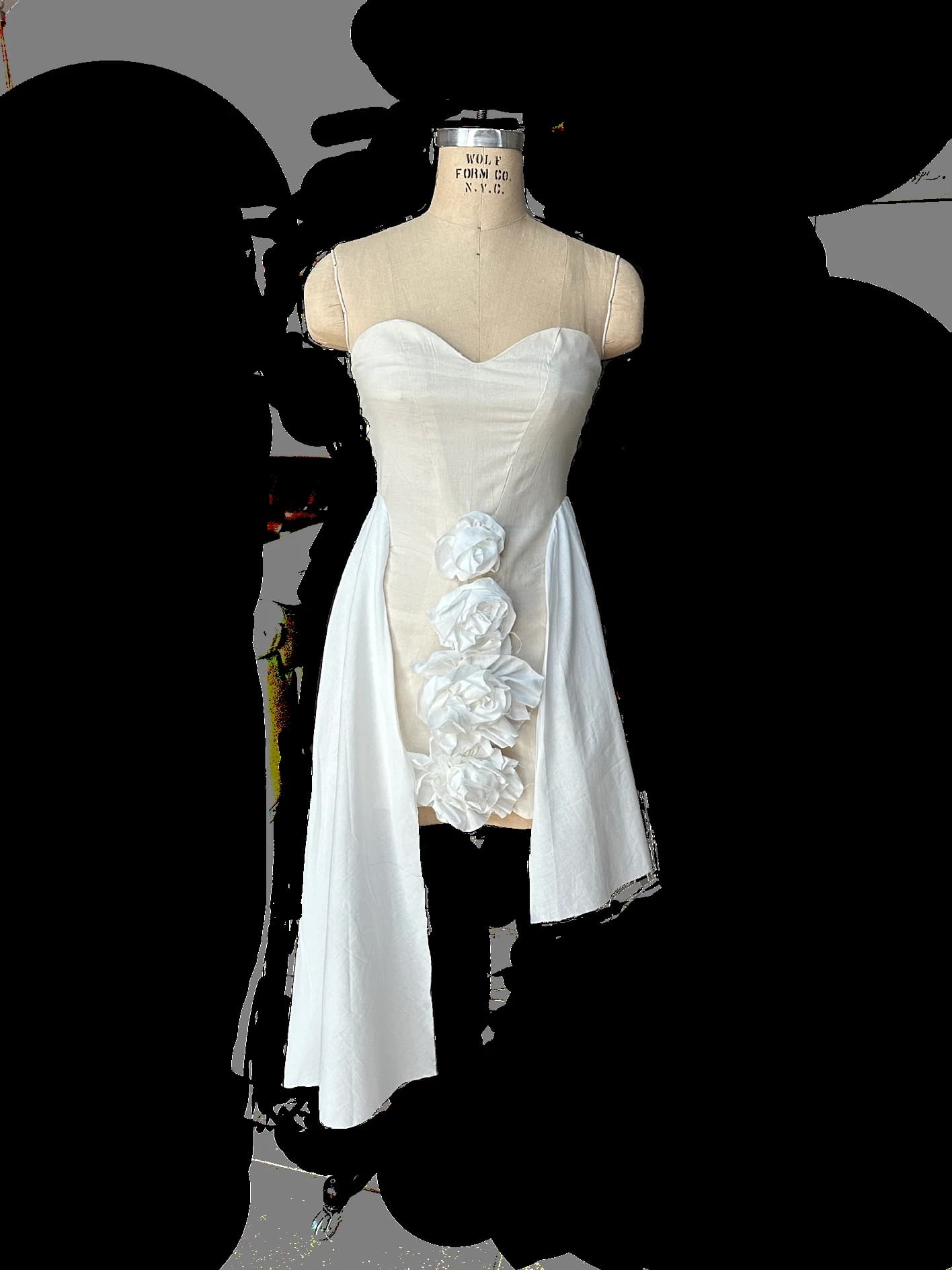 White Passion toile with asymmetric floral construction on a dress form.